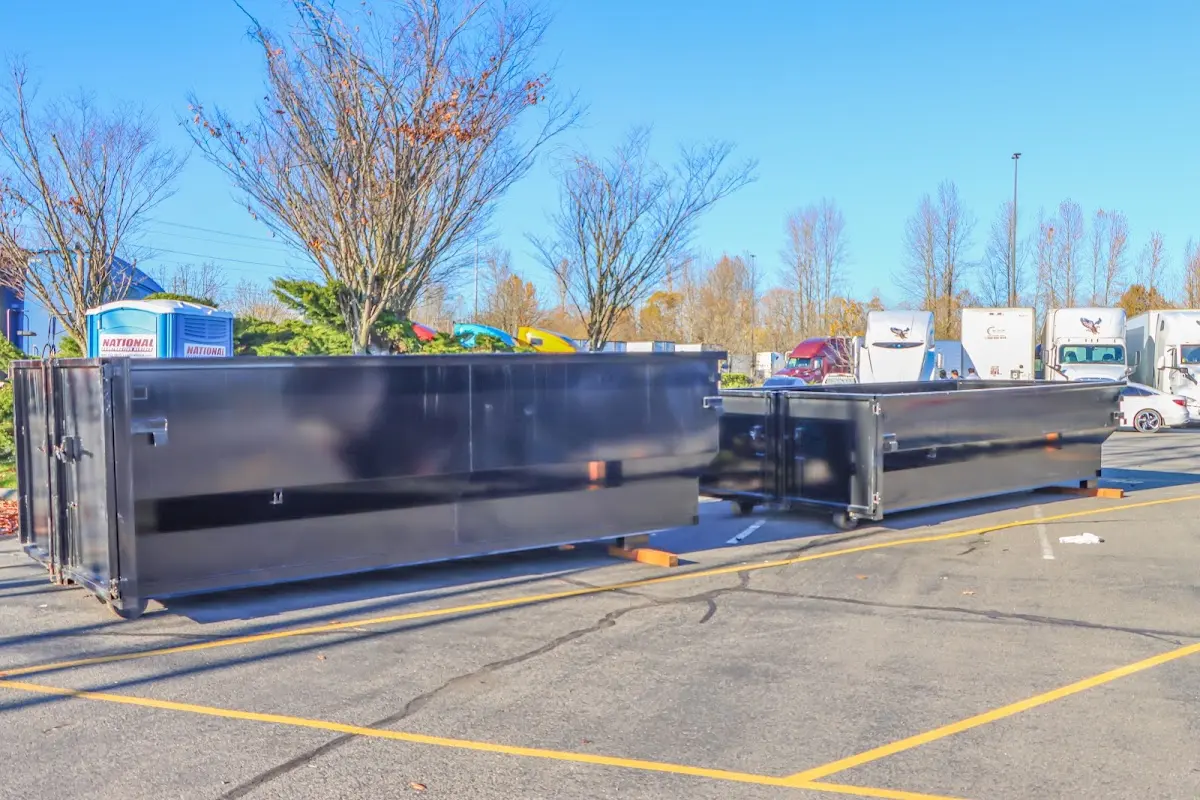 Professional dumpster rental service with roll-off container on residential driveway in Tamaqua